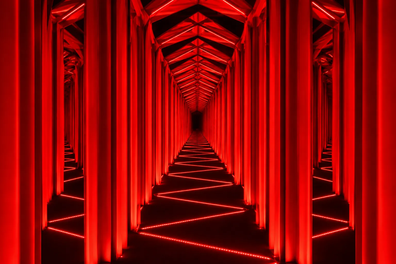 Mirrored red-lit corridor at Cruise Club Cairns repeating into the distance