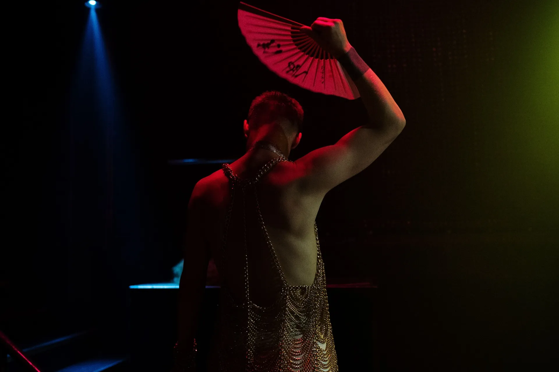 Performer lit in red on the darkened floor at Cruise Club Cairns, a gay club in Cairns